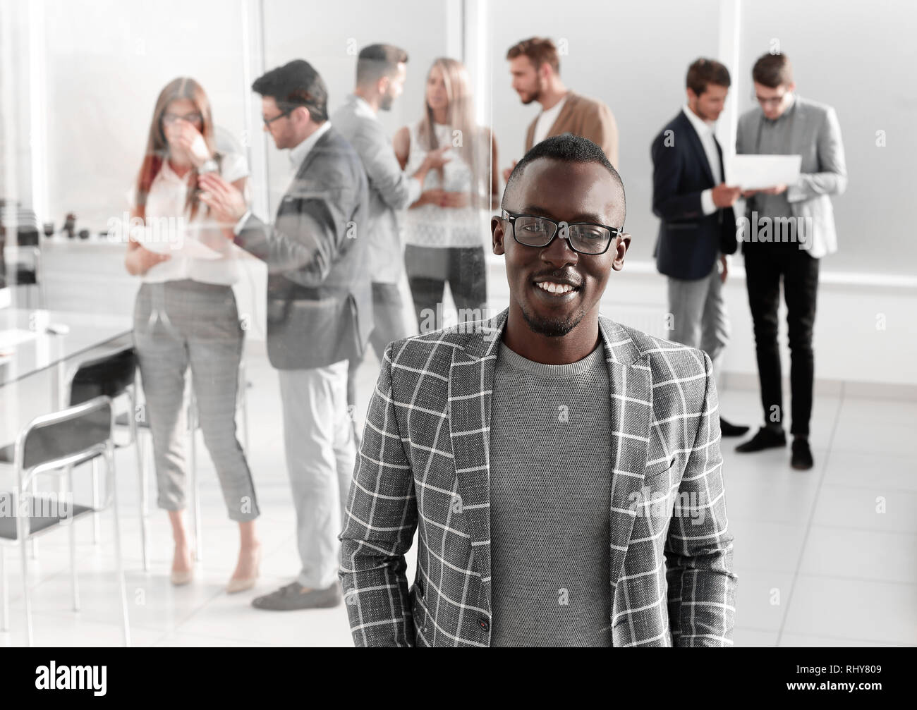 businessman standing in the hall of the modern office Stock Photo - Alamy
