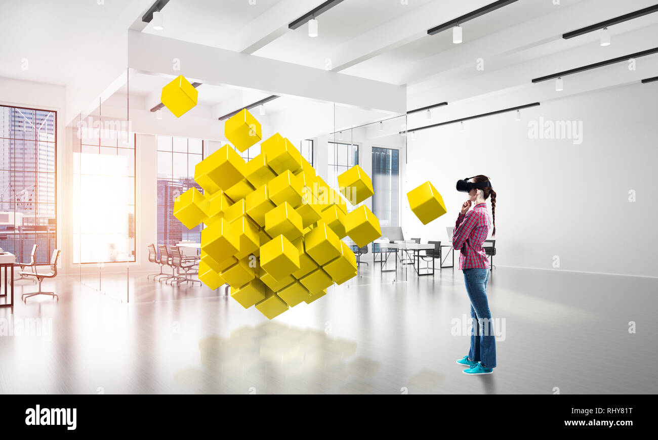 Girl in virtual reality mask experiencing virtual technology world ...