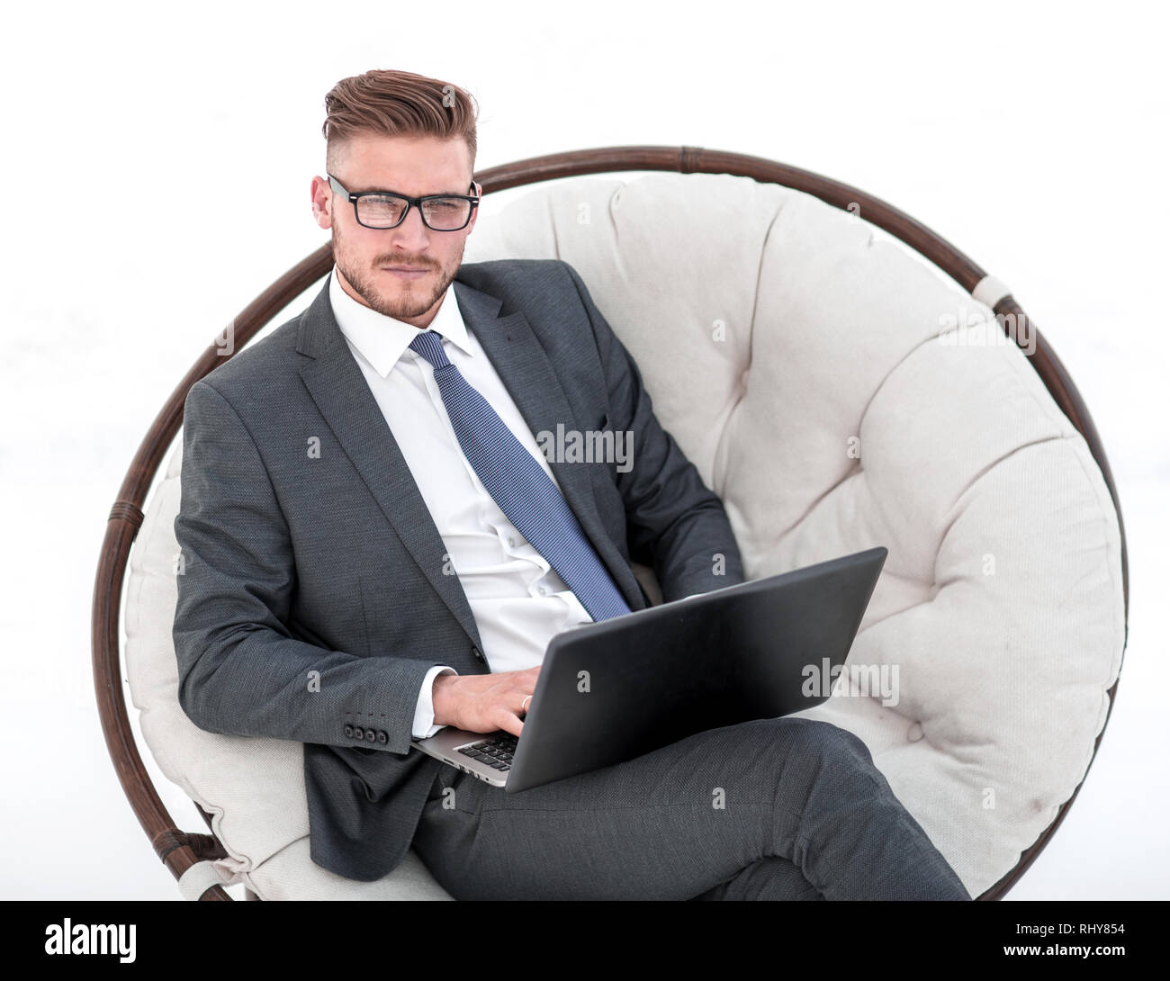 serious businessman with a laptop sitting in a chair Stock Photo - Alamy