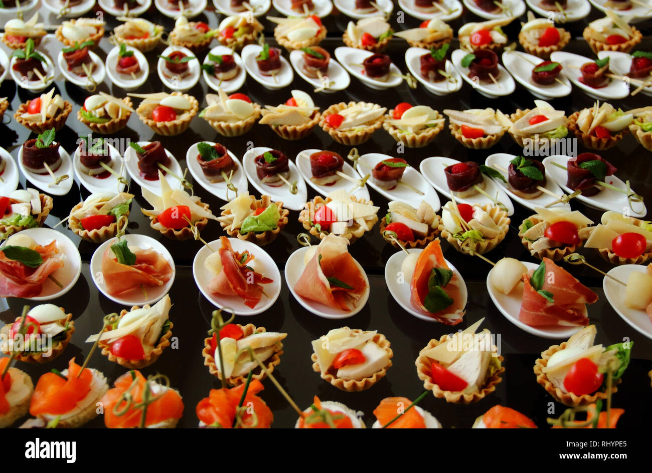 Starters and snacks setting on the white plates served for buffet