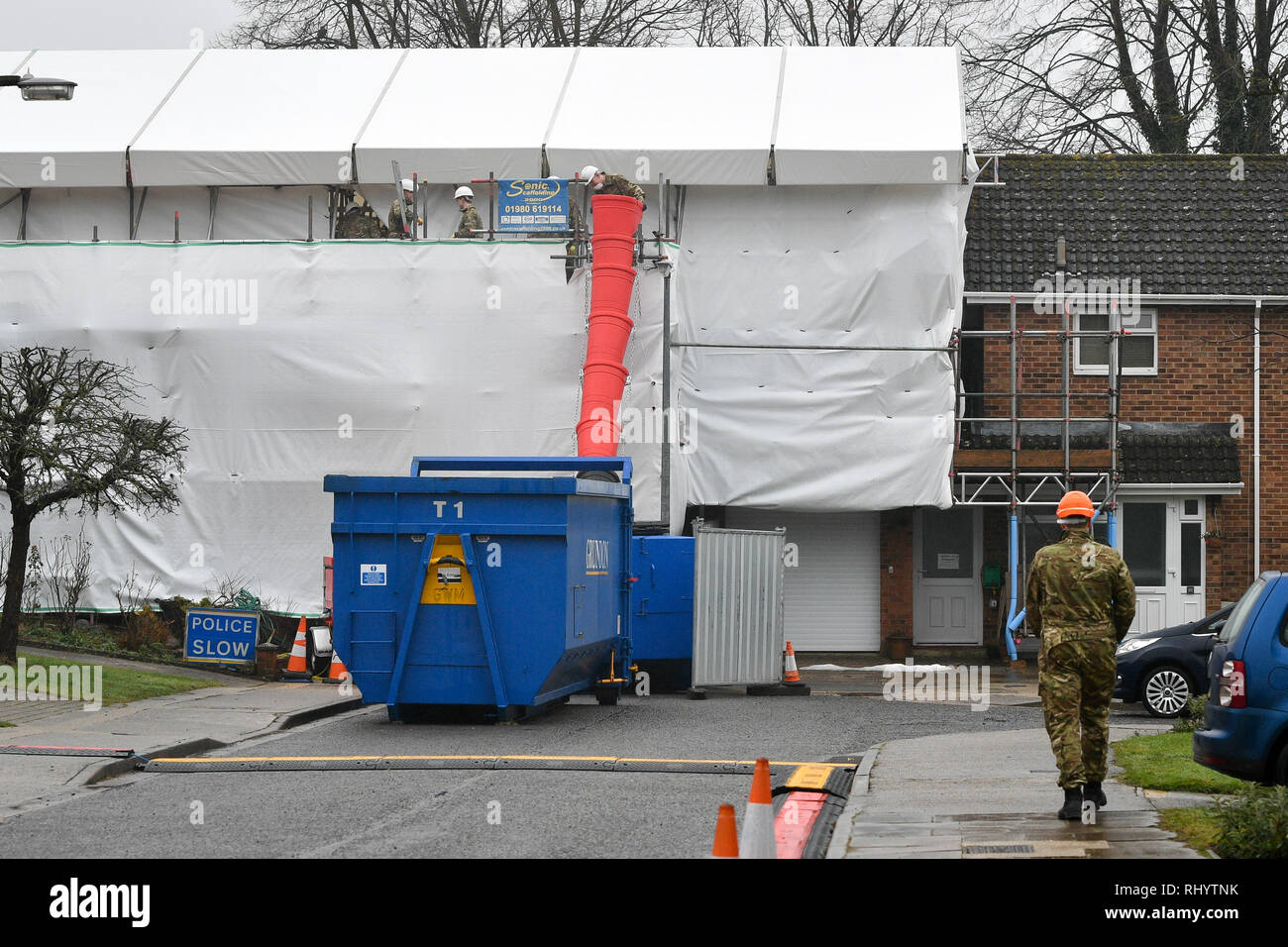 People dressed in British Army fatigues remove bricks and rubble from the Skripal's house in Salisbury, where the roof is being taken down after the novichok attack. Stock Photo