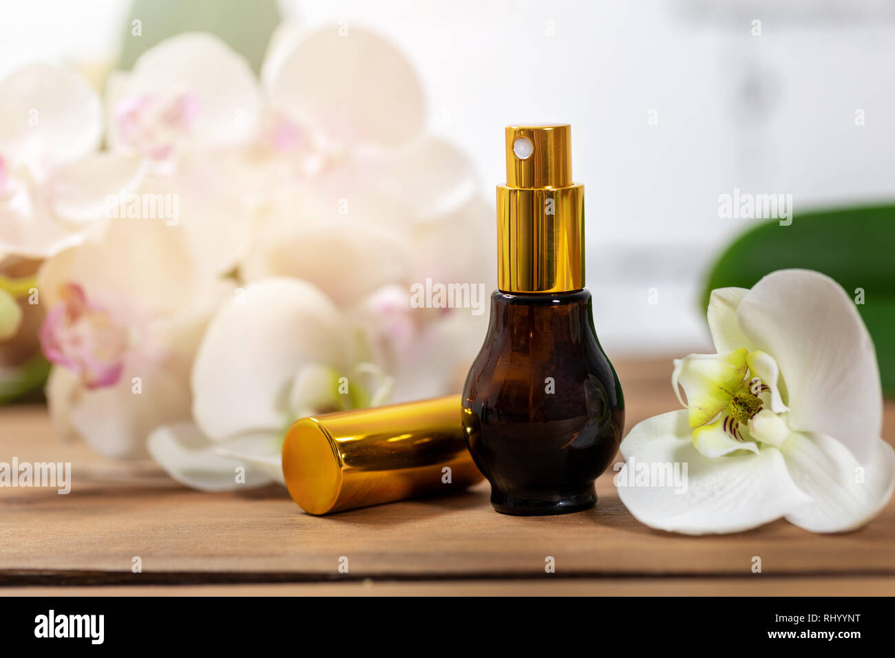 floral scent perfume atomizer with orchid flower Stock Photo