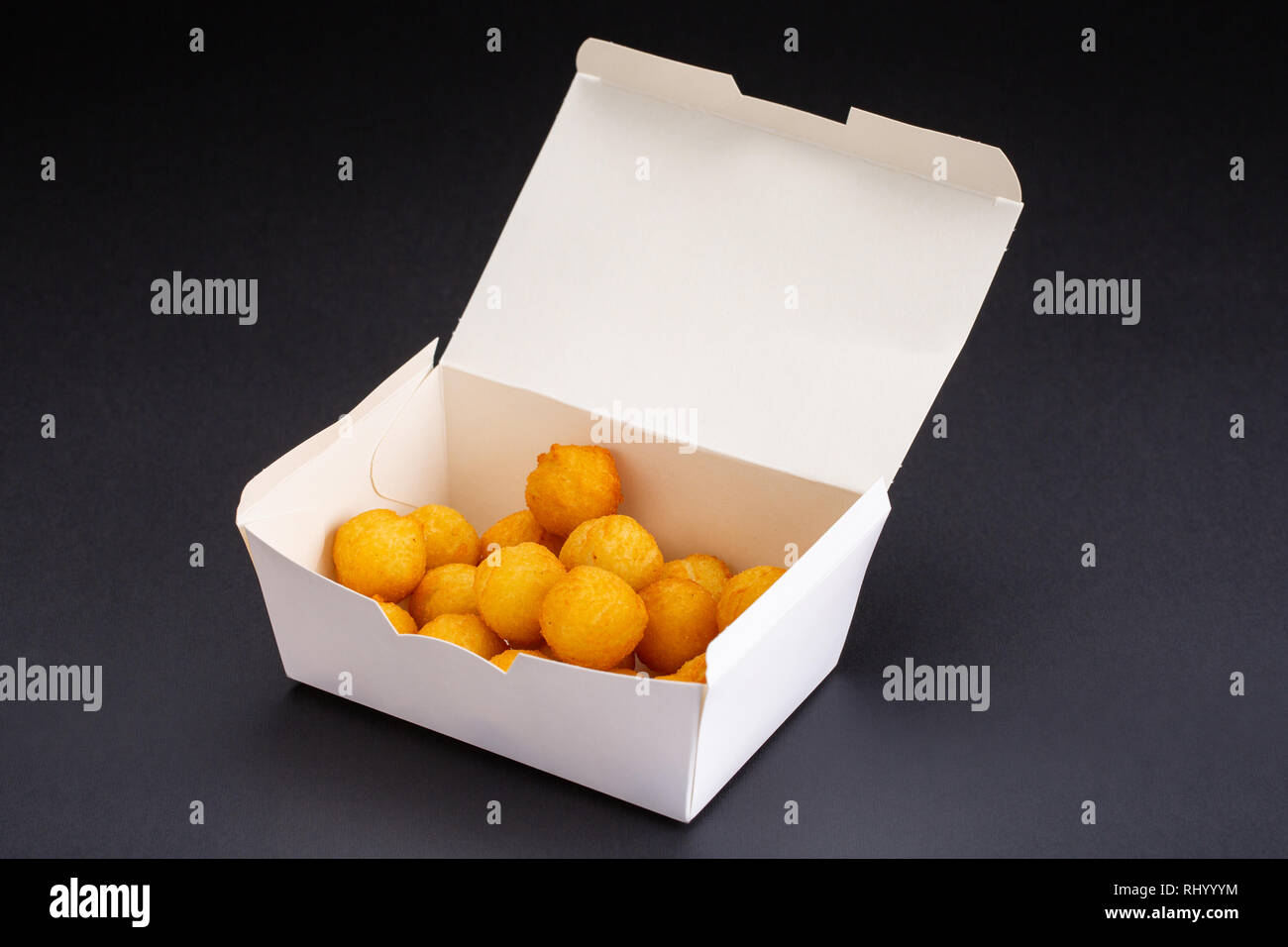 fried chicken balls in a whitebox on a black background. studio picture of fried chicken balls Stock Photo