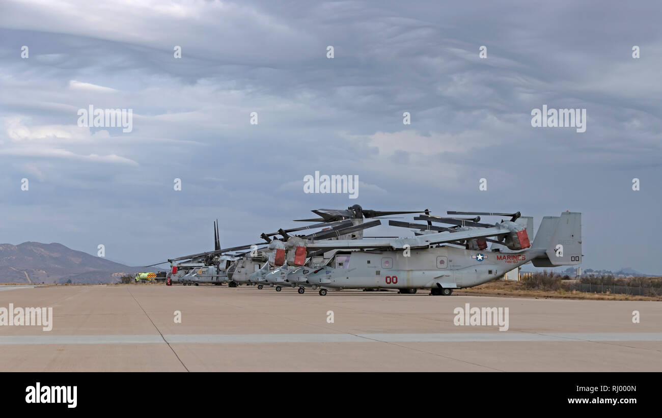 Military helicopters and Osprey troop transports on the runway at Miramar Stock Photo