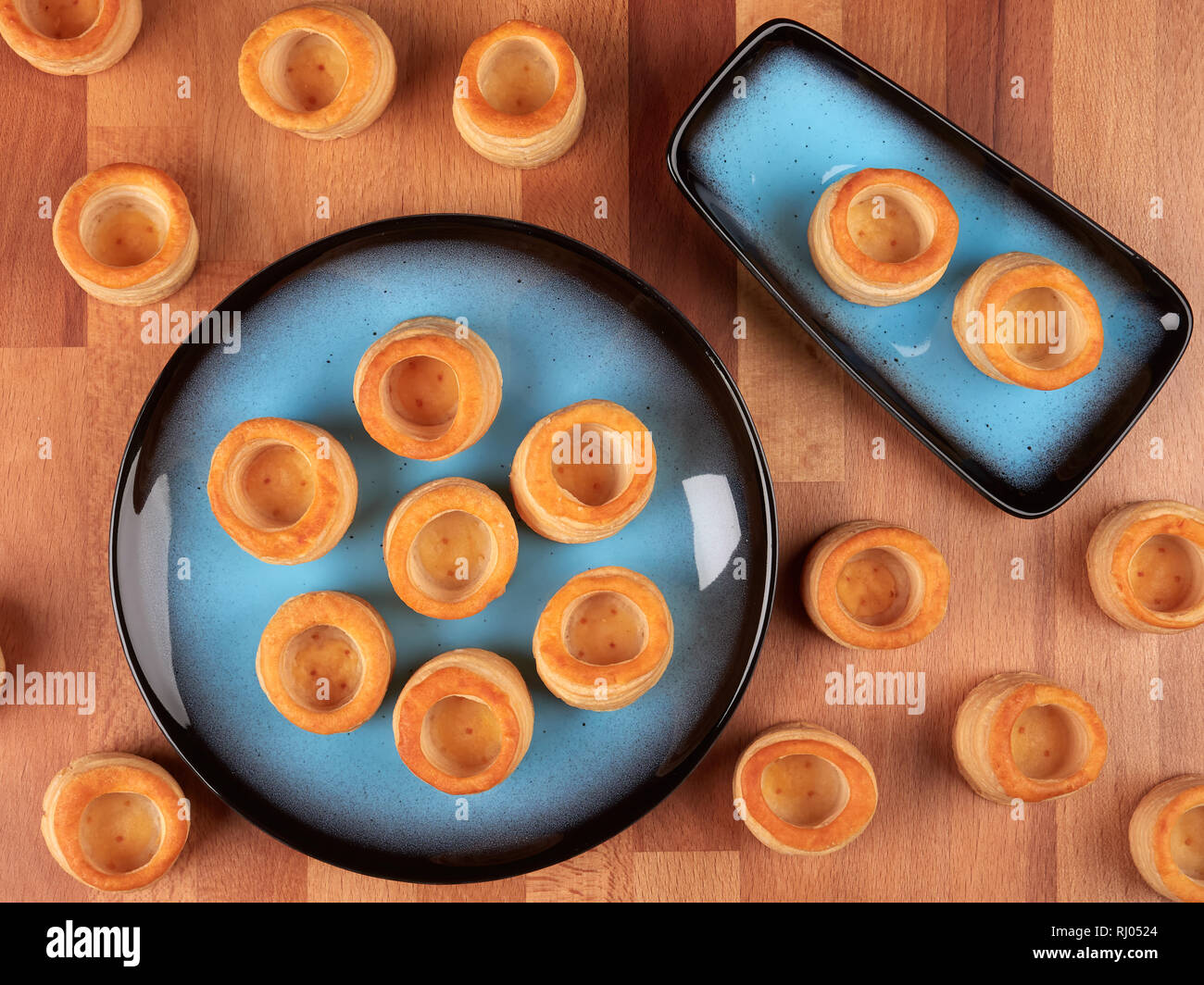 Readymade small puff pastry shells, on a wooden board Stock Photo Alamy