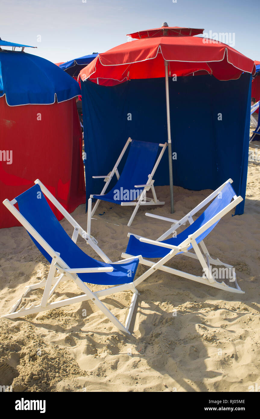 Colourful deck-chairs and sunshades on the beach at Deauville, Normandy, France. Stock Photo