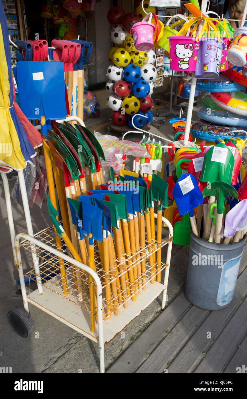 Colourful plastic toys on sale on the boardwalk in Deauville, Normandy, France. Stock Photo