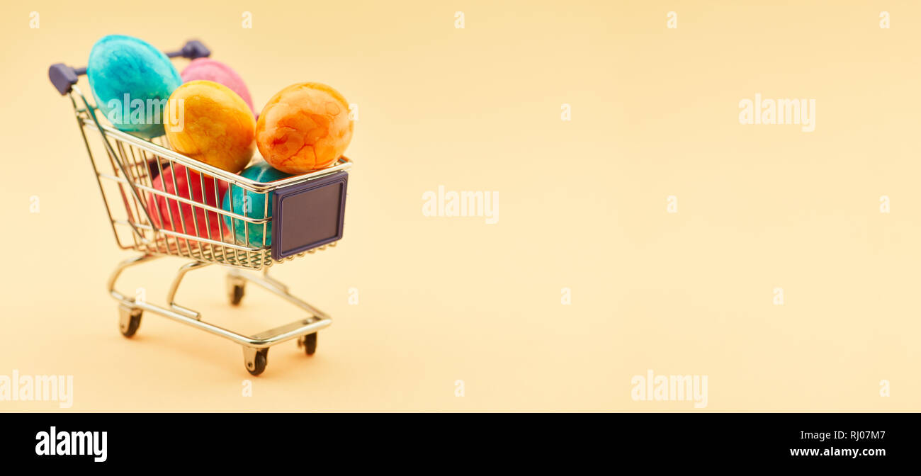 Easter panorama header with shopping cart full of Easter eggs Stock Photo