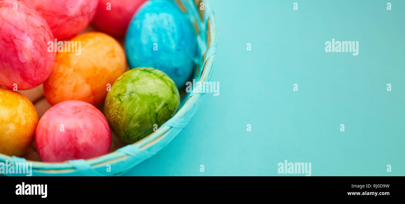 Many colorful easter eggs in basket as easter banner header with copy ...