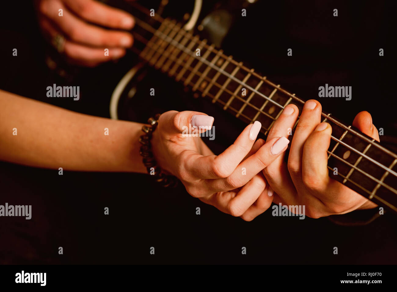We love music. Couple in love play duets. Male and female hands play