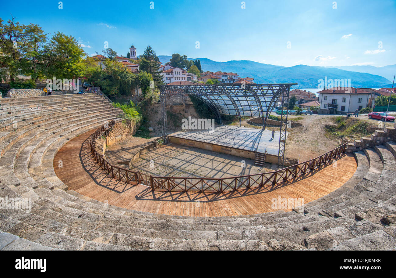 The antique ancient greek amphitheater. Theatre of Ohrid with view on old town and Lake Ohrid. Ohrid, Republic of Macedonia. UNESCO site Stock Photo
