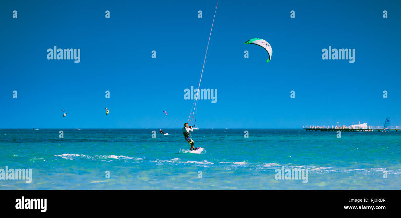 Egypt, Hurghada - 30 November, 2017: The kiter gliding over the Red sea surface. The amazing panoramic view. The lone sportsman among the calm sea water. The outdoor activity. Extreme sport. Stock Photo