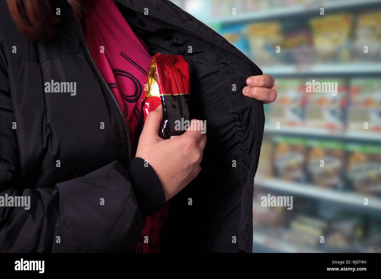 Woman shoplifting in a store Stock Photo