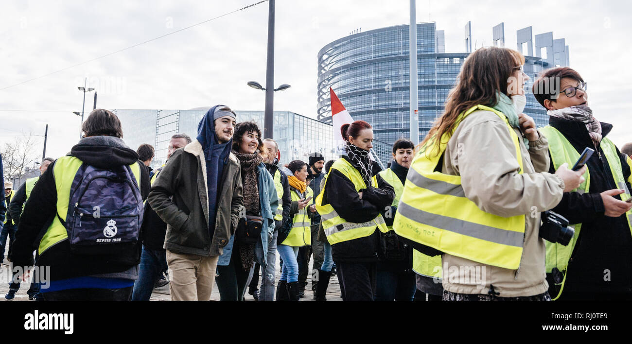 STRASBOURG, FRANCE - FEB 02, 2018: Crowd of people demonstrating in front of European Parliament during protest of Gilets Jaunes Yellow Vest manifestation on the 12 Saturday of anti-government demonstrations Stock Photo