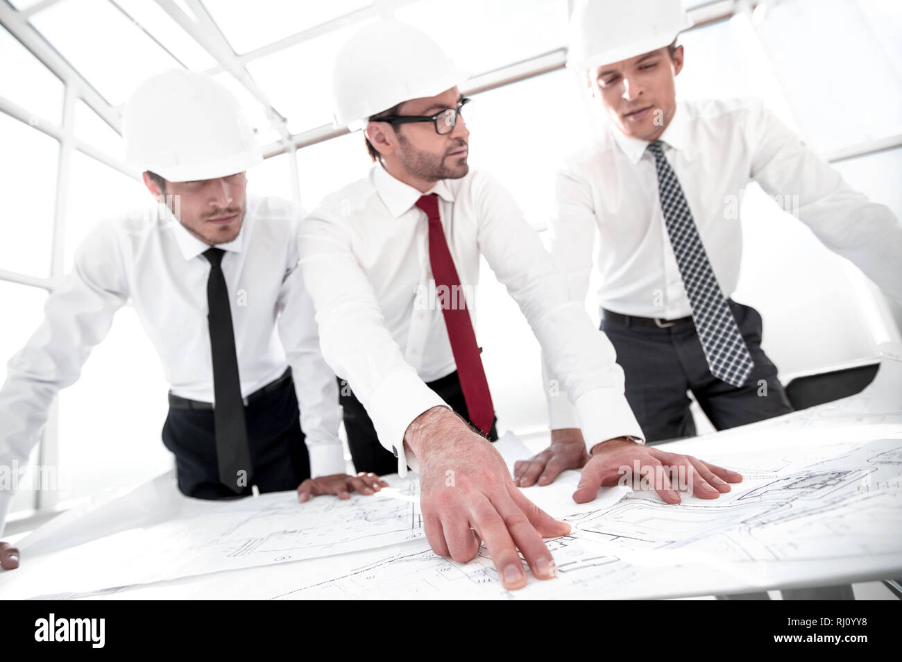 group of architects discussing sketches Stock Photo