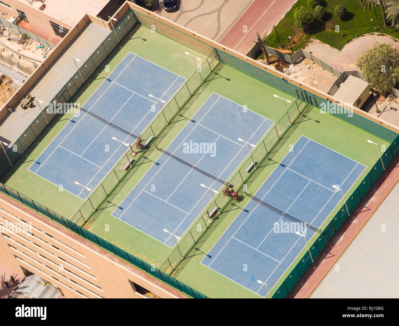 Three tennis courts on the roof of a building in Dubai Stock Photo - Alamy