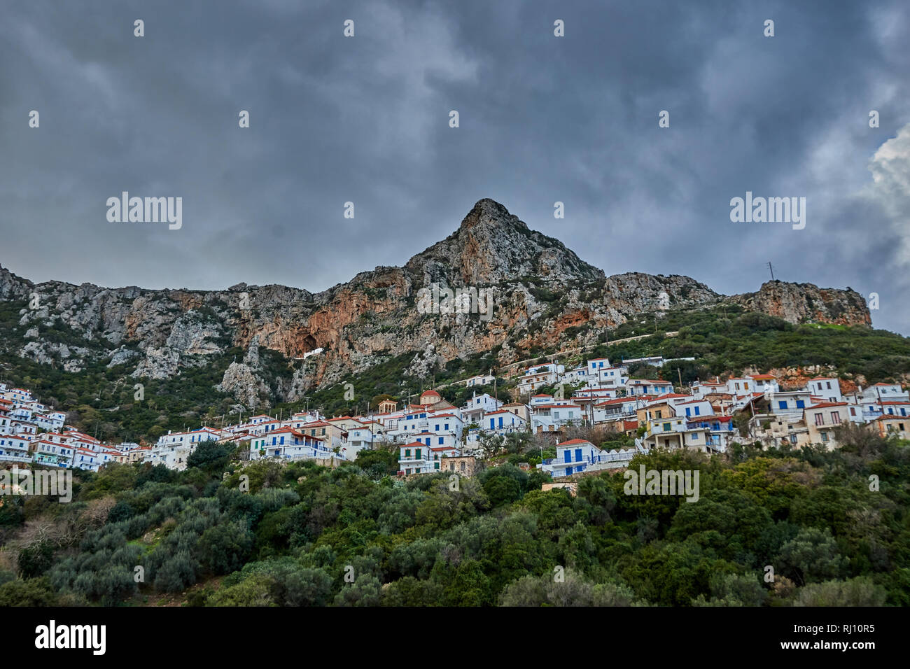 the Historical Byzantine village Velanidia near cape Malea, Greece. In the Cave above the village is visible the Holy Monastery of Zoodochos Pighi. Stock Photo