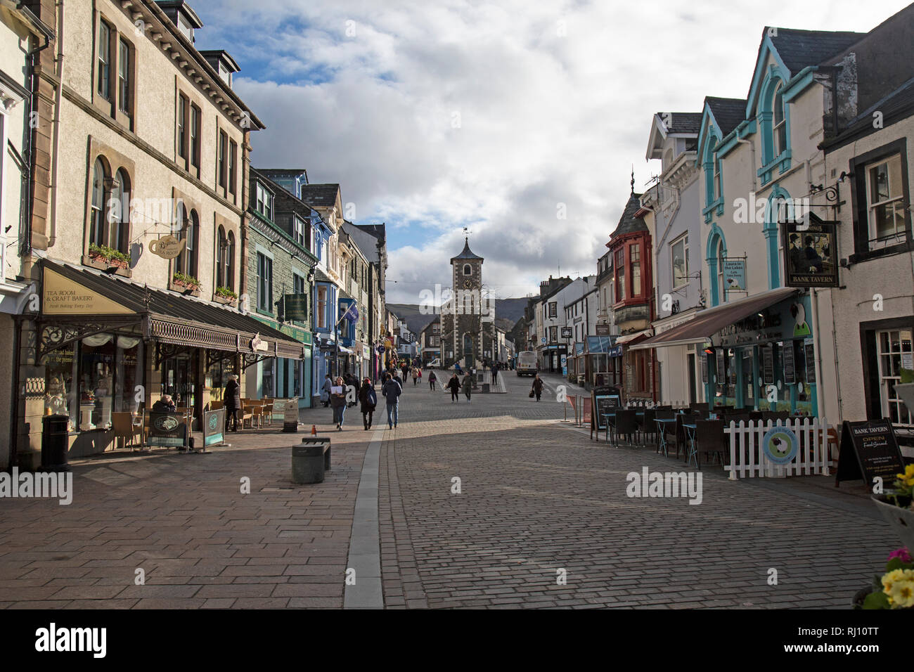 Main Street in Keswick, a town in the Lake District National Park in Cumbria, England. Shops, bars, pubs and restaurants all visible. Stock Photo