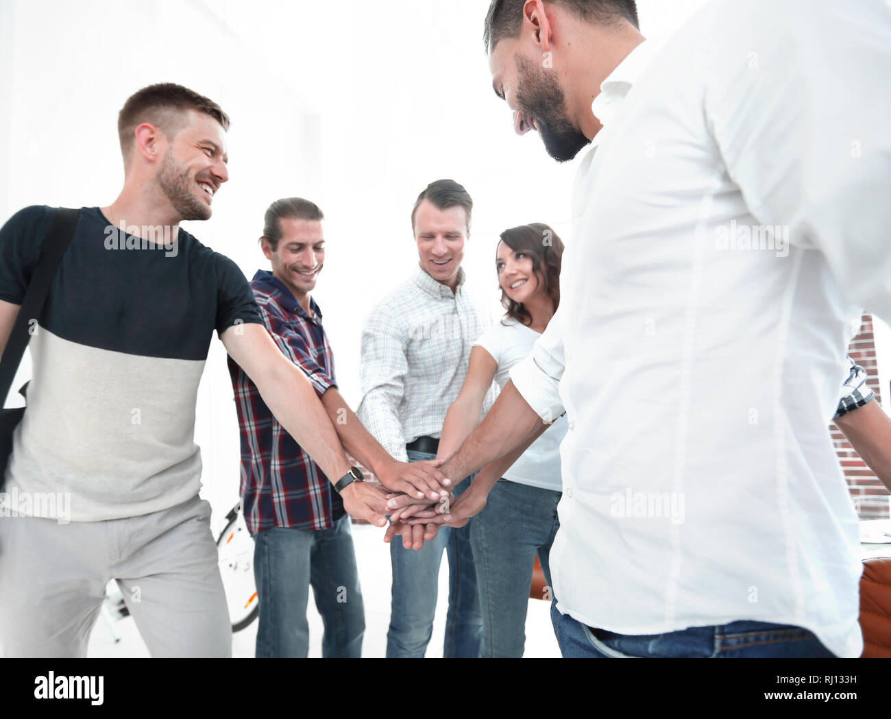 .friendly team of designers clasped their hands together Stock Photo