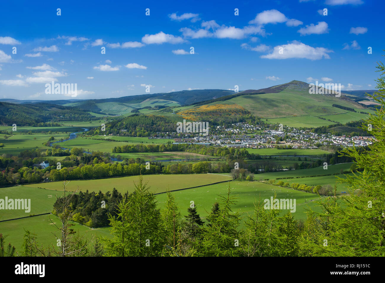 Looking over Traquair House in the Tweed Valley, the town of Innerleithen nessling under Lee Pen in the back ground Stock Photo