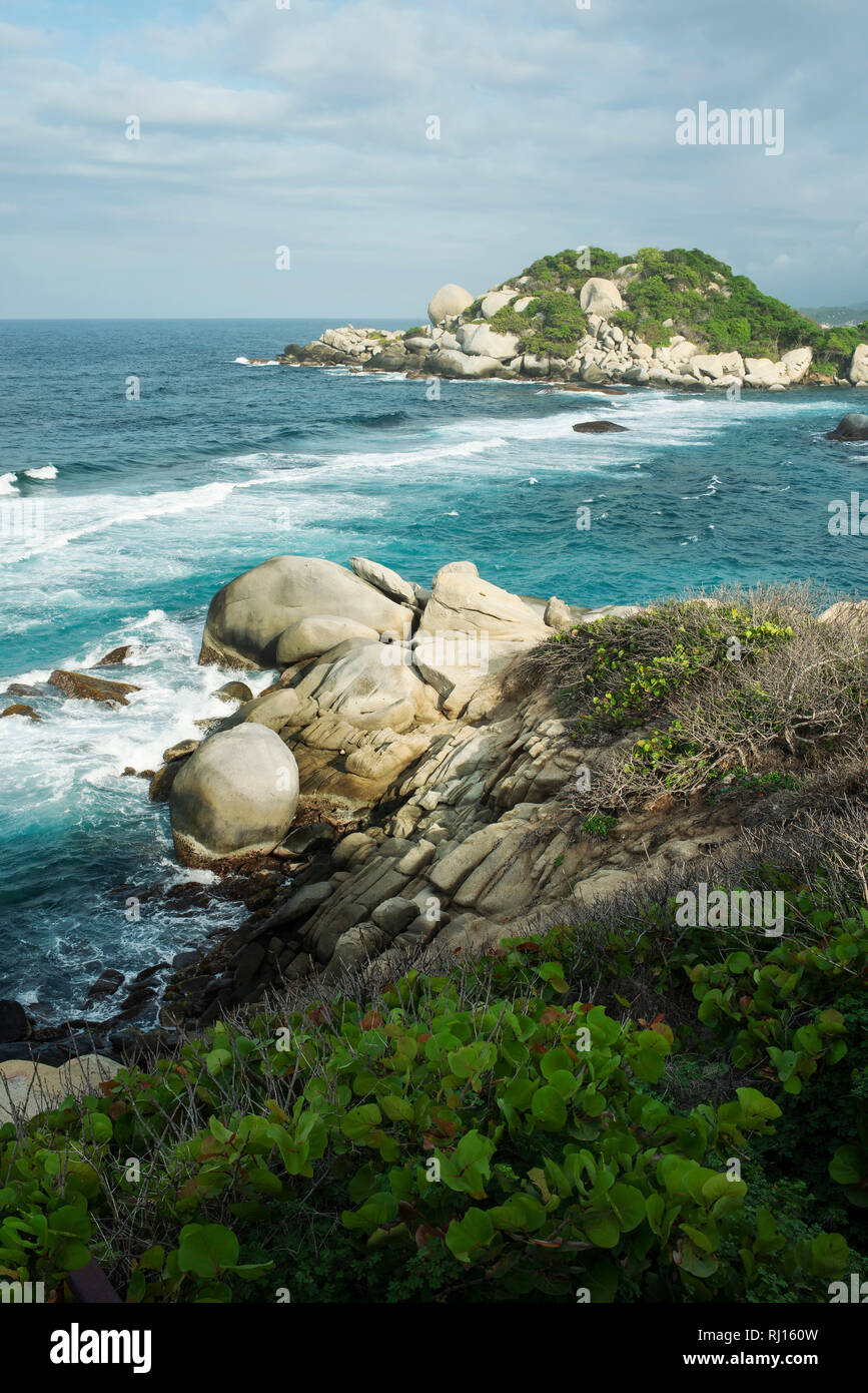 Vertical views of tropical coastline and turquoise water with rocks at Arrecifes Beach. Tayrona Park, Colombia. Sep 2018 Stock Photo
