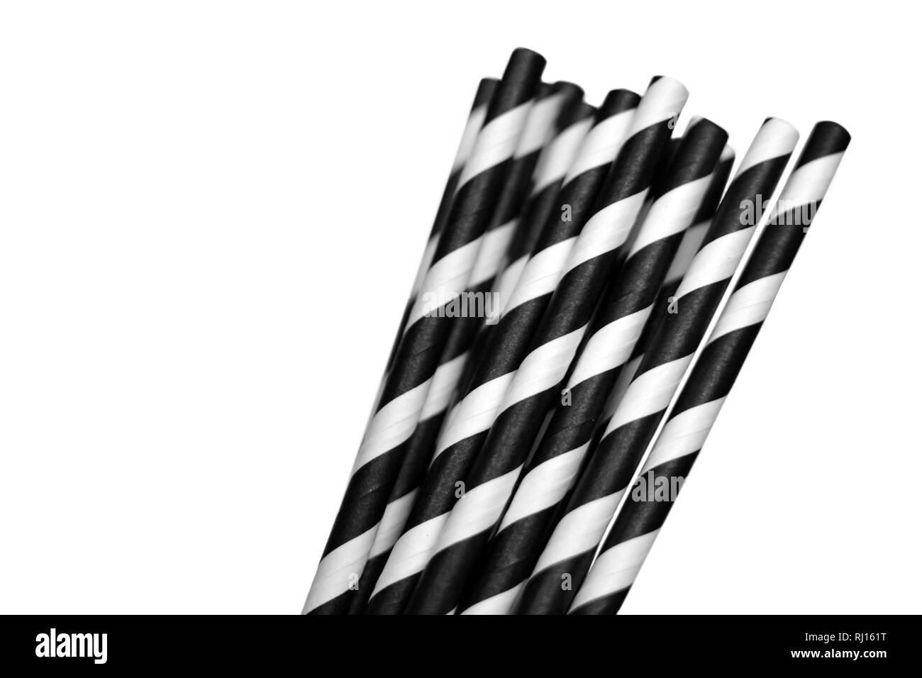 Black and white striped ecologically friendly paper drinking straws isolated on white background Stock Photo