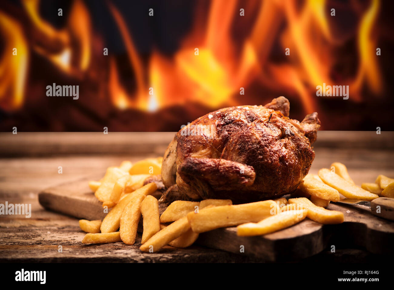 Grilled chicken with fire grill background Stock Photo Alamy
