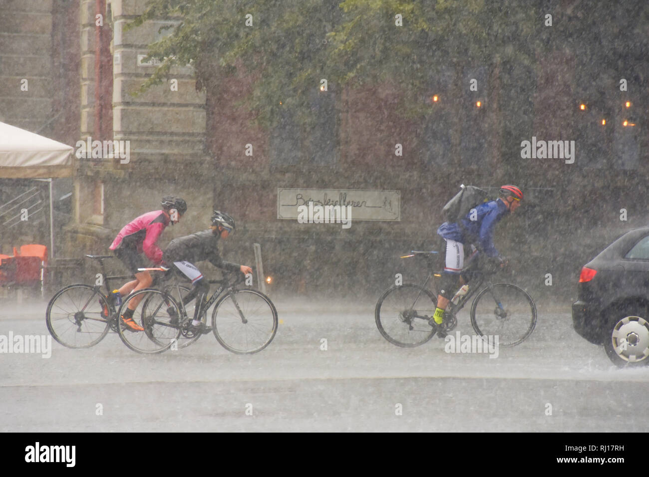 Riding a bicycle in the rain, Bergen Norway Stock Photo