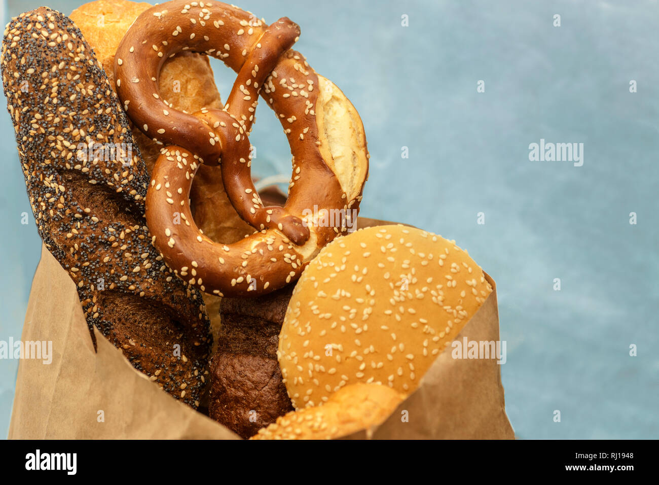 Various kinds of pastry with blur background, assorted pastries, bread, pretzel, baguette, croissant, buns close up, selective focus Stock Photo