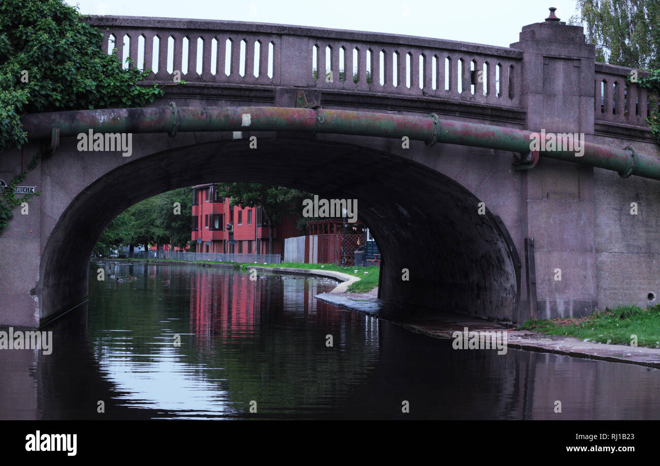 Arched road bridge over canal Stock Photo