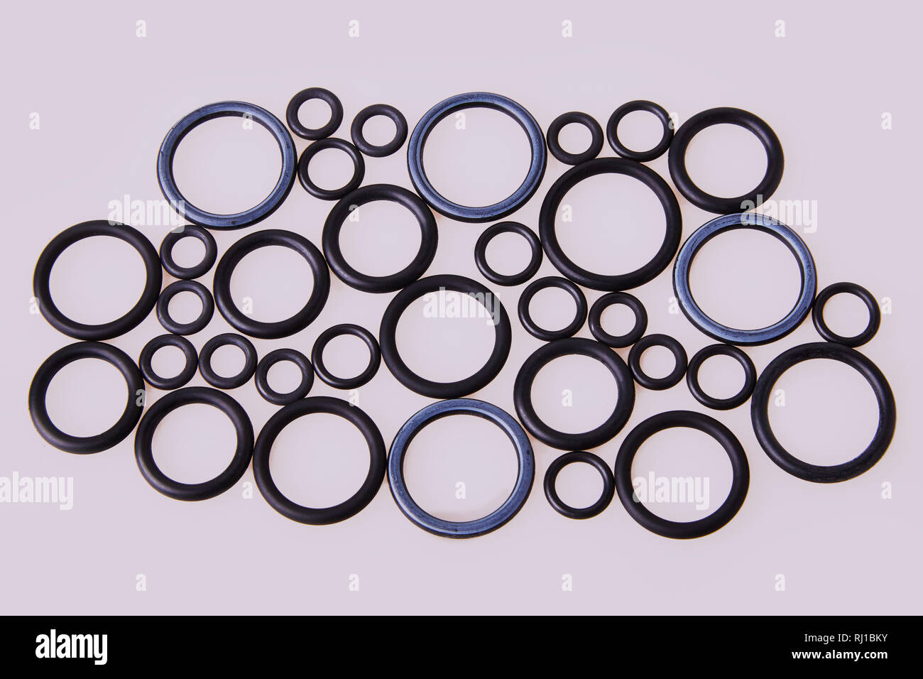 Black hydraulic and pneumatic oring seals of different sizes scattered