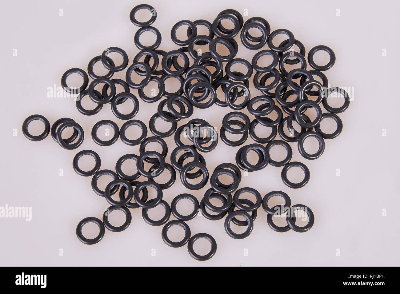 Black hydraulic and pneumatic oring seals of different sizes scattered