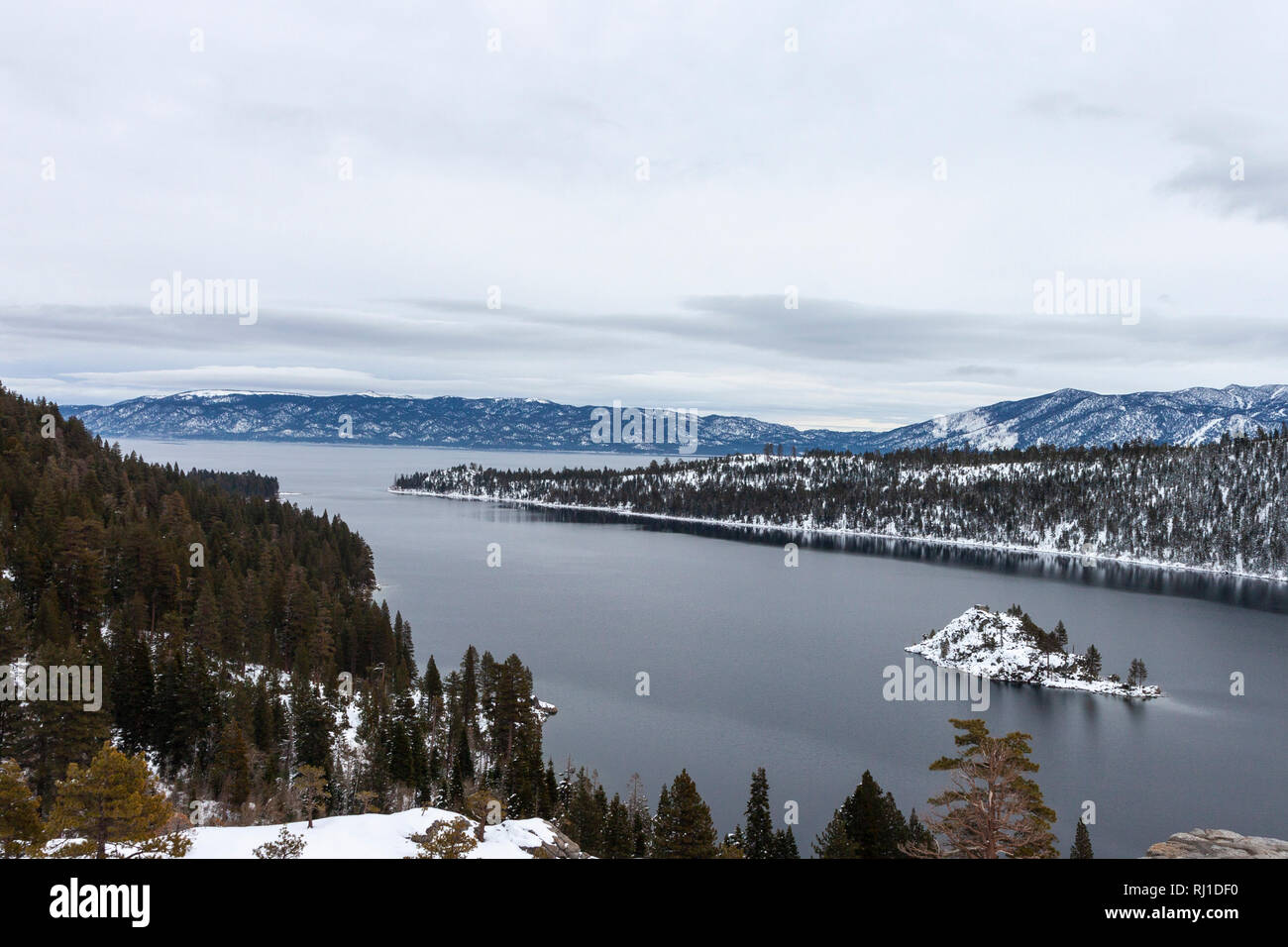Lake Tahoe's Emerald Bay with Fannatte Island covered in snow. Slightly overcast skies. Stock Photo