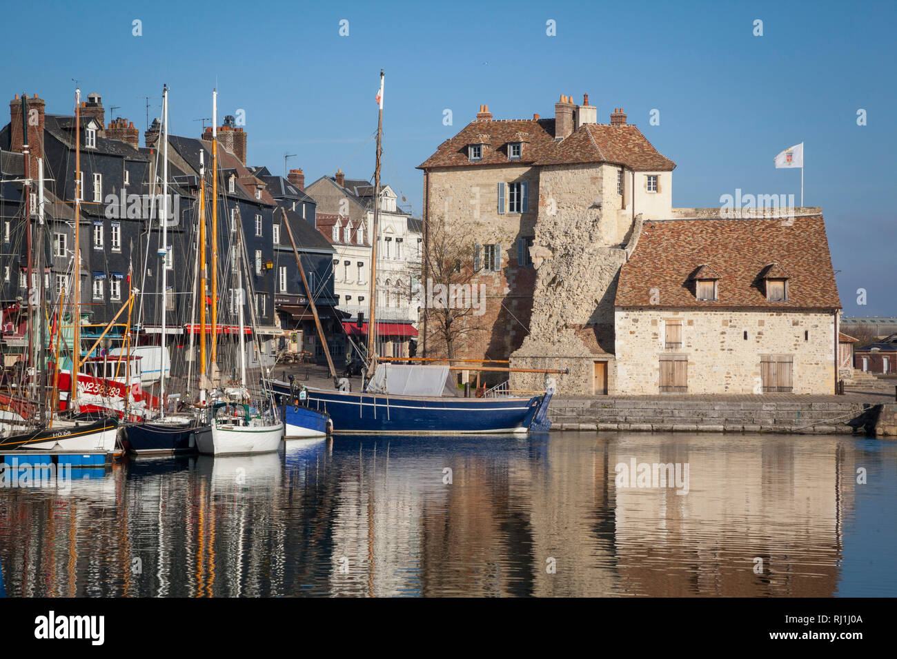 The Honfleur flag flies on La Lieutenance, situated on the harbour or