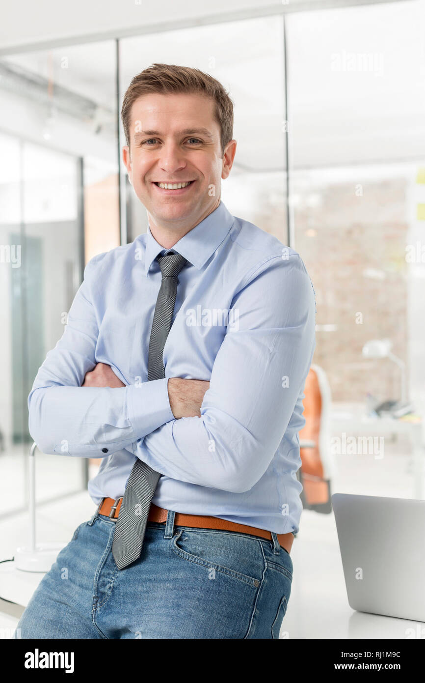 Portrait of businessman with arms crossed in office Stock Photo - Alamy