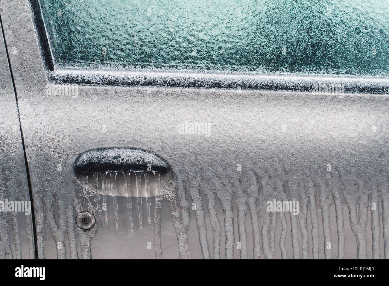 Front View Closeup Of Silver Car Door Lock And Handle Frozen
