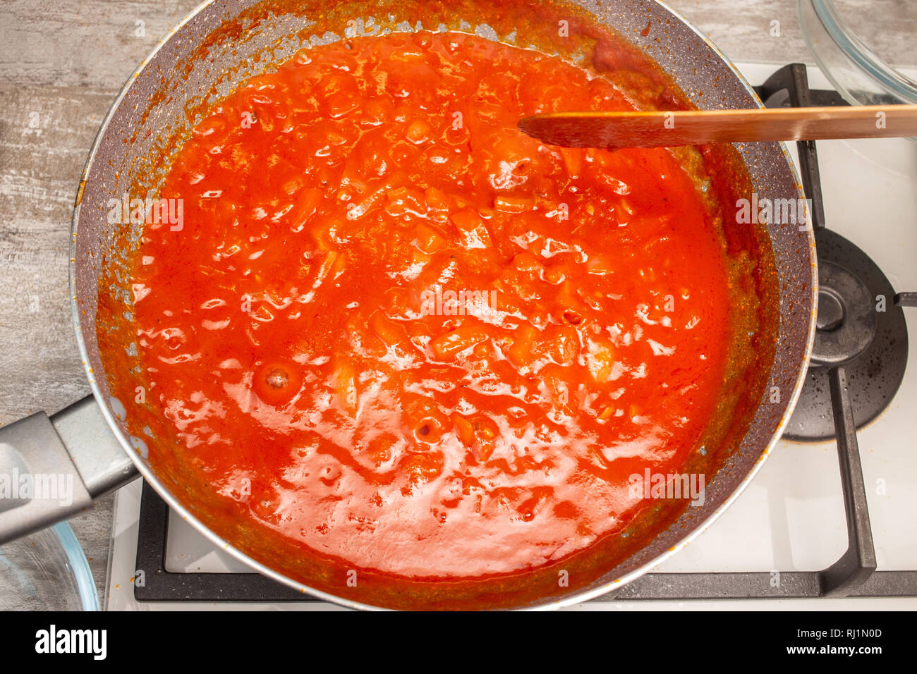 preparation homemade hot tomato sauce on home kitchen Stock Photo