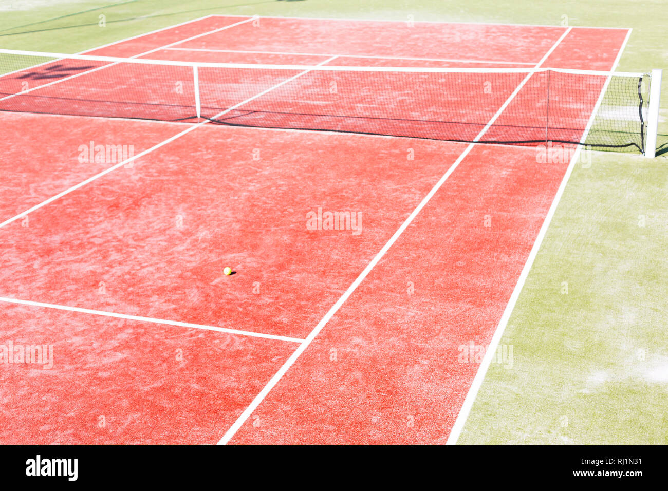 High angle view of empty red tennis court on sunny day Stock Photo