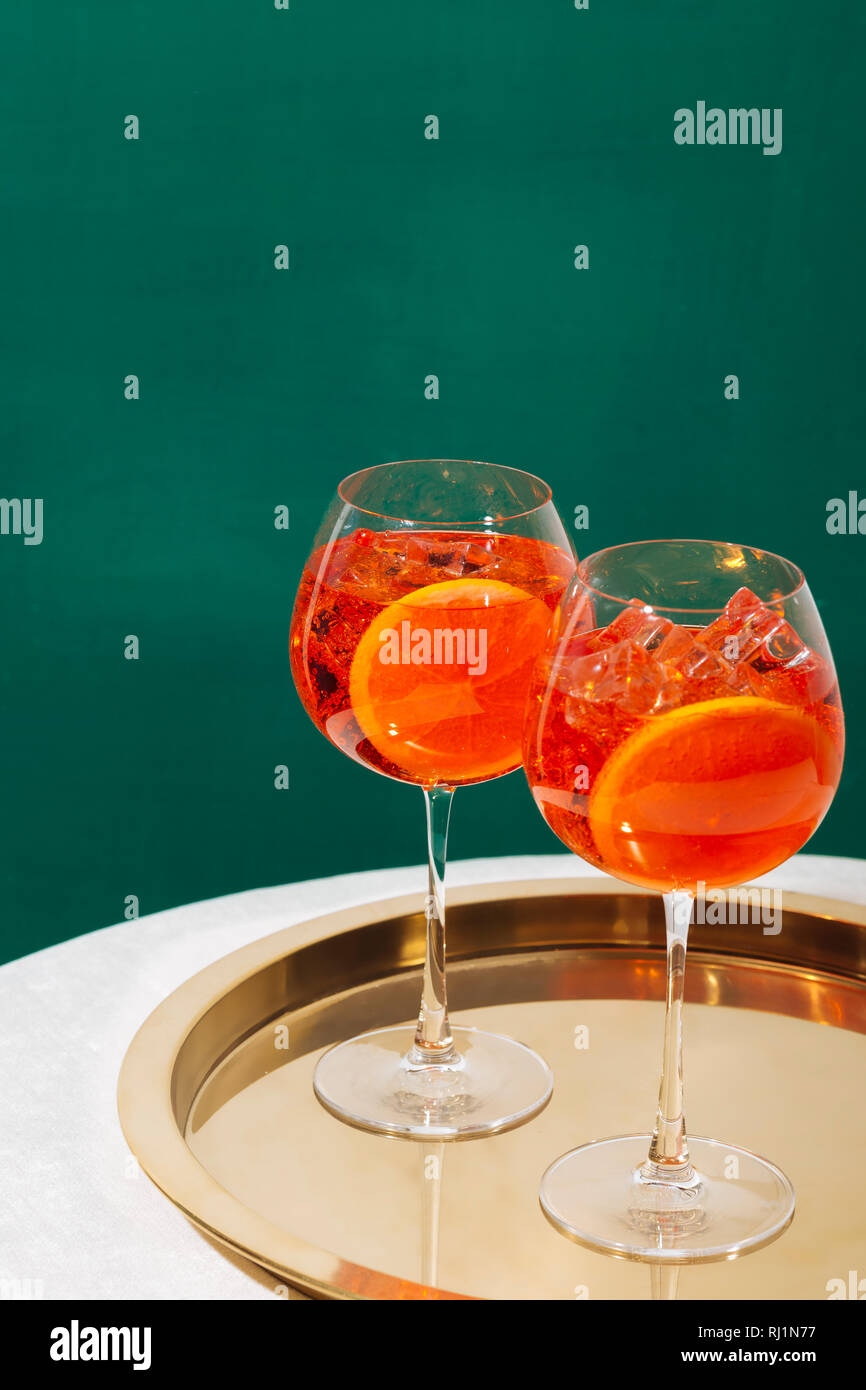 Spritz veneziano, an IBA cocktail, with Prosecco or white sparkling wine, bitter, soda, ice and a slice of orange, in a calix on a table, pop graphic Stock Photo