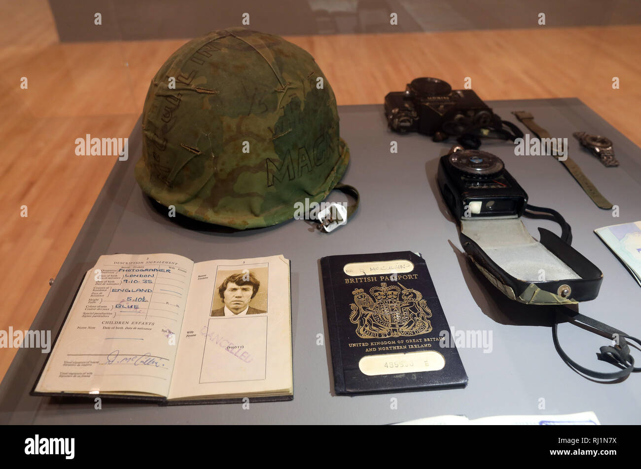 Pic shows: Possessions of Don McCullin on display including  His passport and visa stamps from the Vietnam war. US Army helmet Nikon Camera body with  Stock Photo