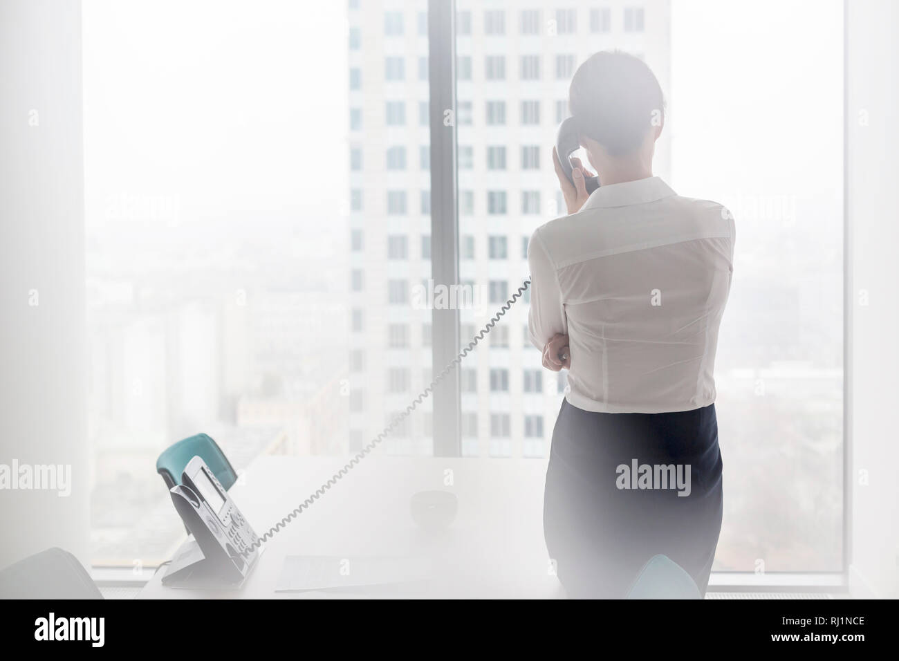 Woman landline rear view hi-res stock photography and images - Alamy