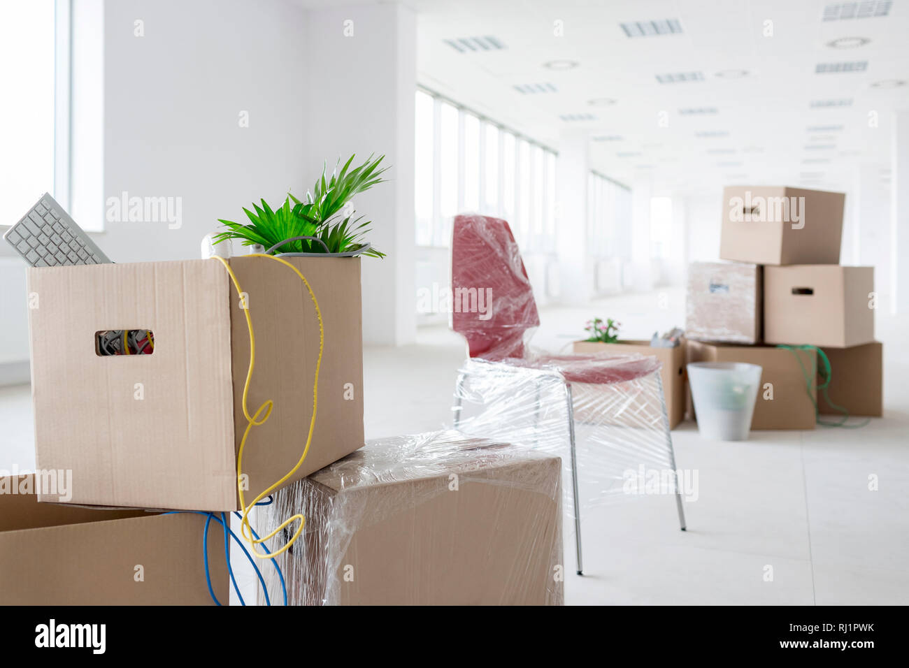 Cardboard boxes in new empty office Stock Photo