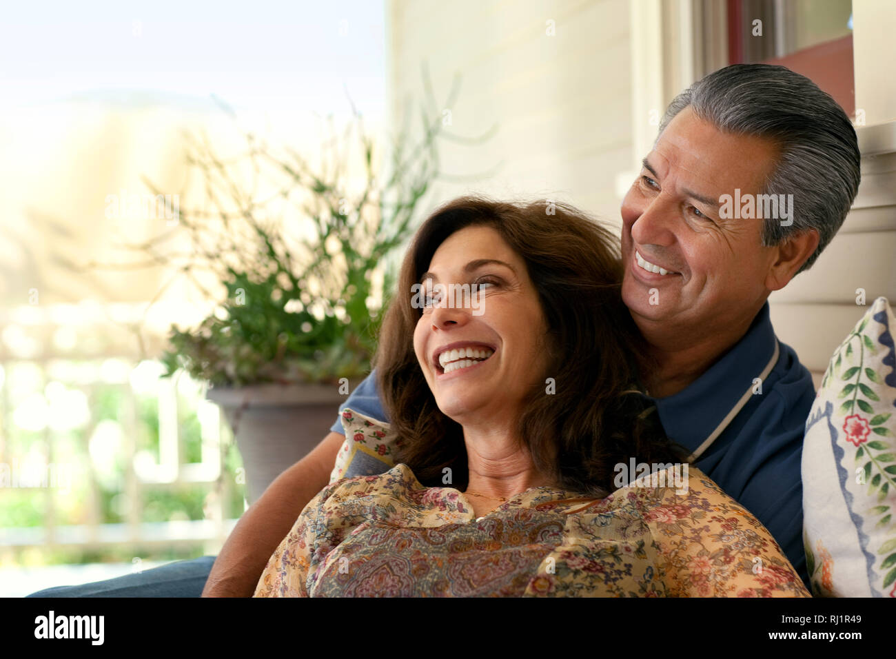 Couple relaxing on their verandah. Stock Photo