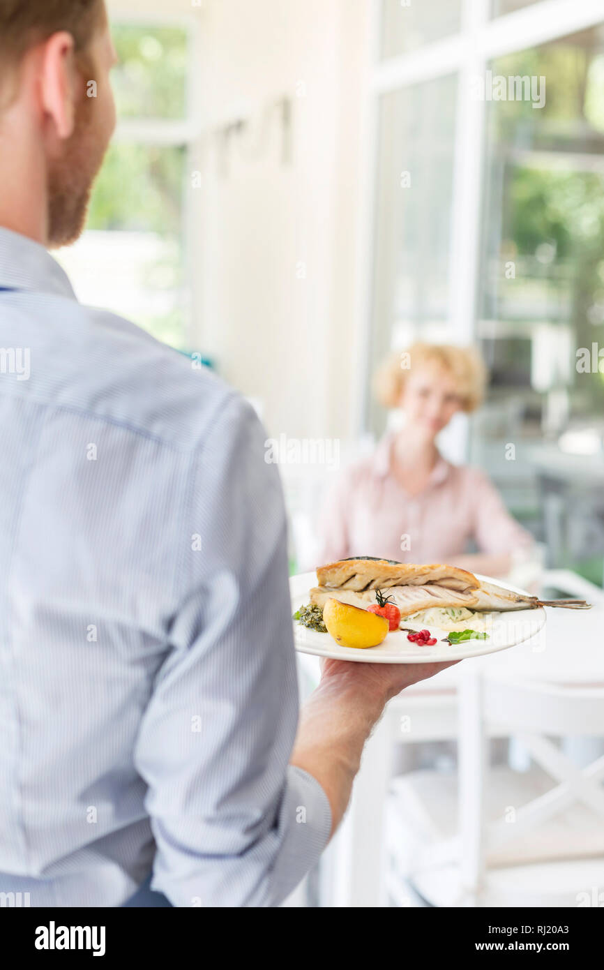 Waiter serving food restaurant hires stock photography and images Alamy