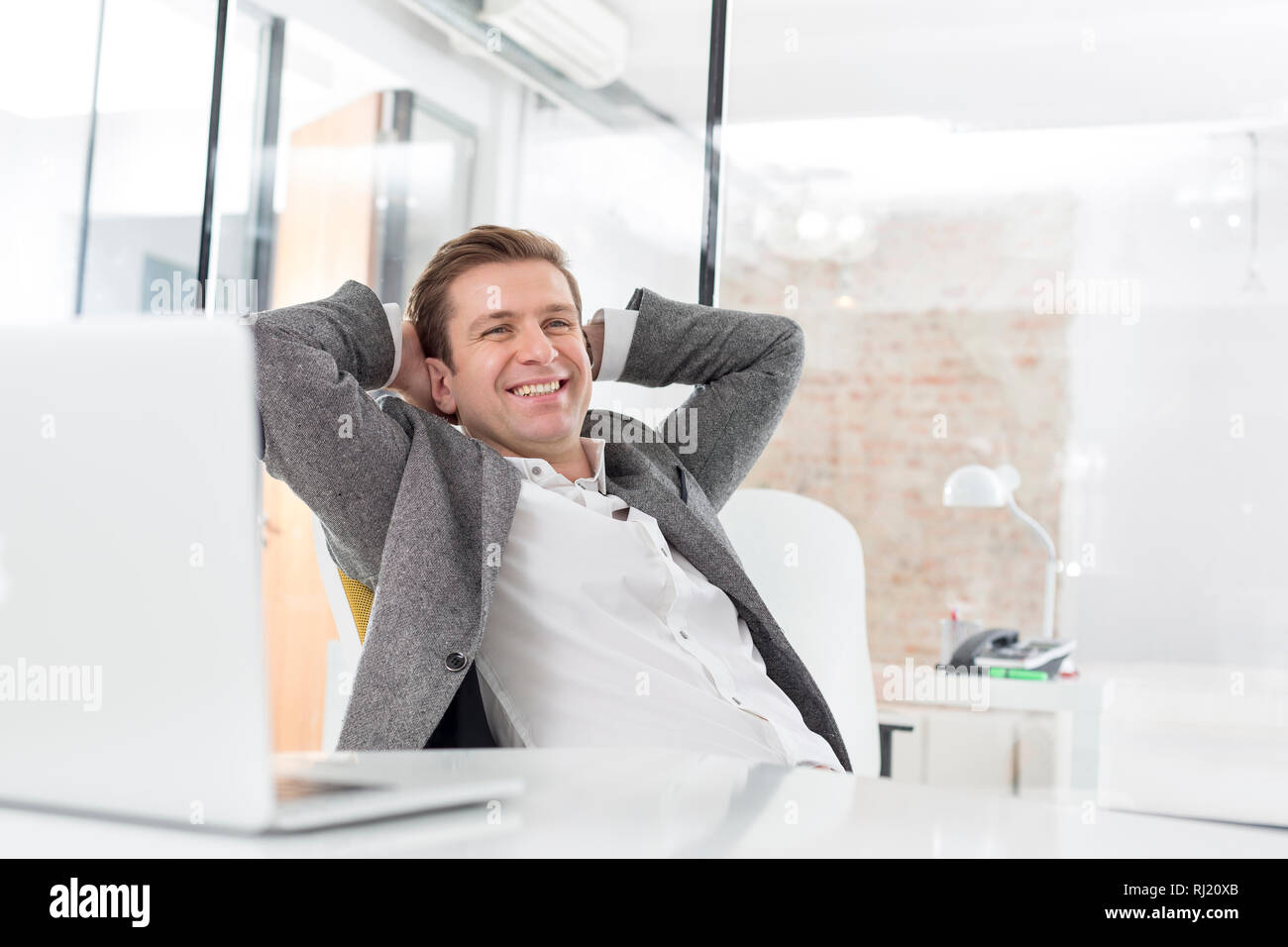 Sitting behind desk hi-res stock photography and images - Alamy
