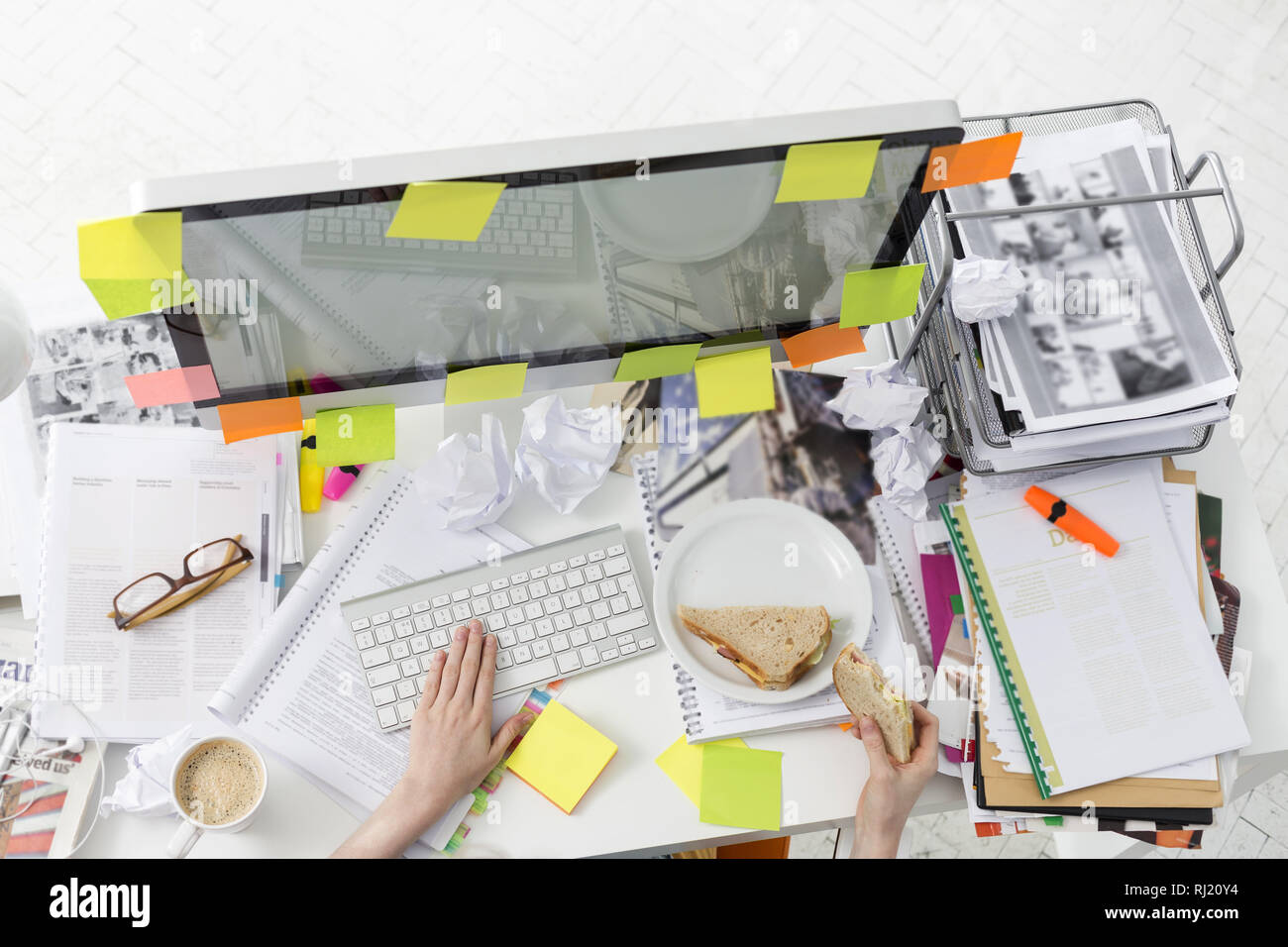 Cropped image of businessman having breakfast while working on computer Stock Photo