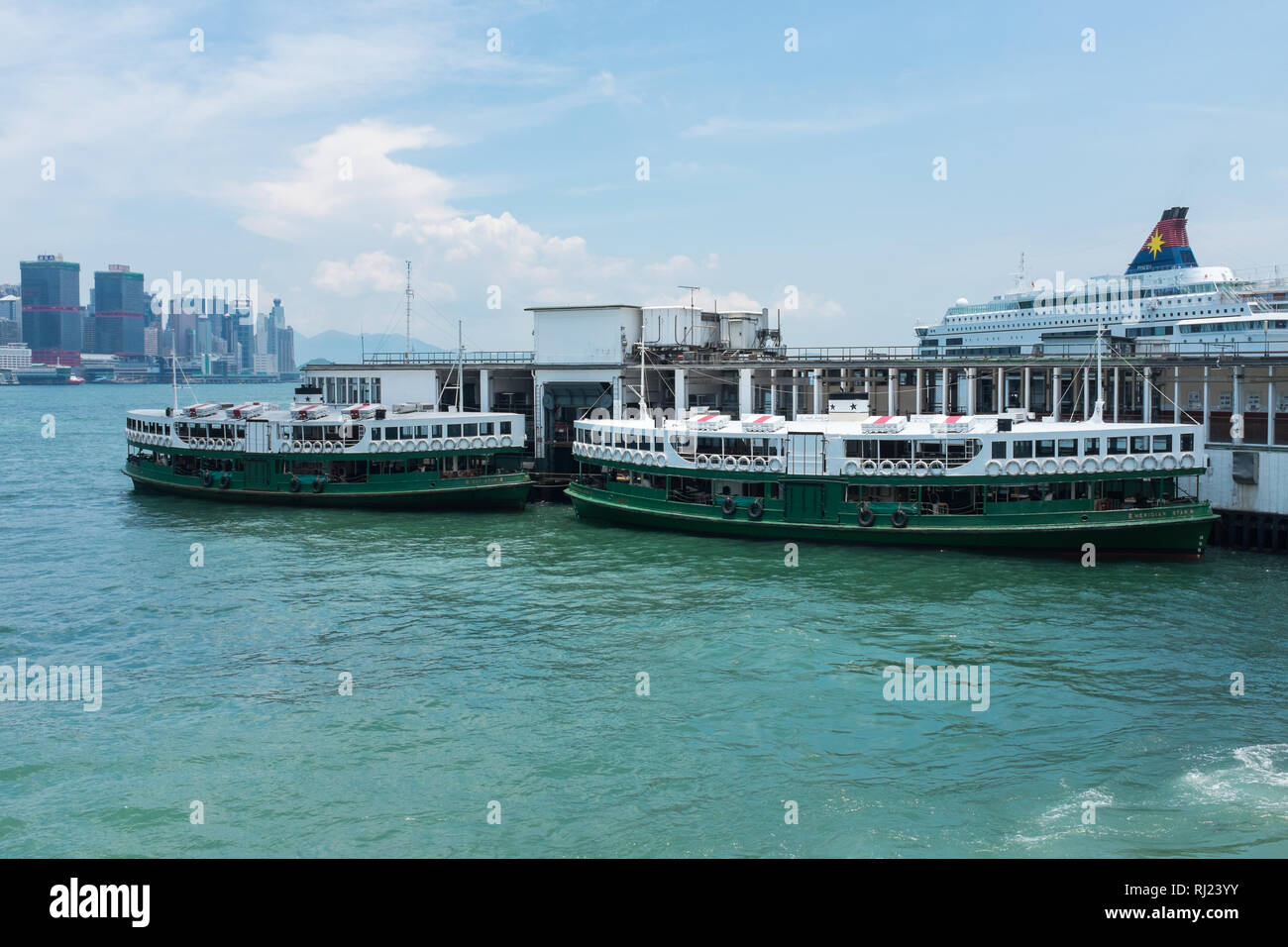 Green and white Star Ferries docked at the Star Ferry Pier on Tsim Sha Tsui, Hong Kong Stock Photo