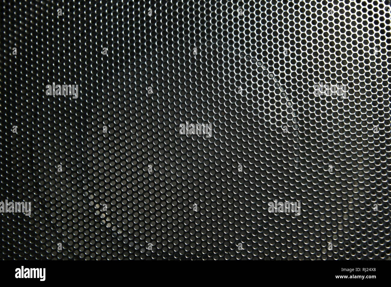 The speaker of a musical column hidden behind a grid with a pattern of ...
