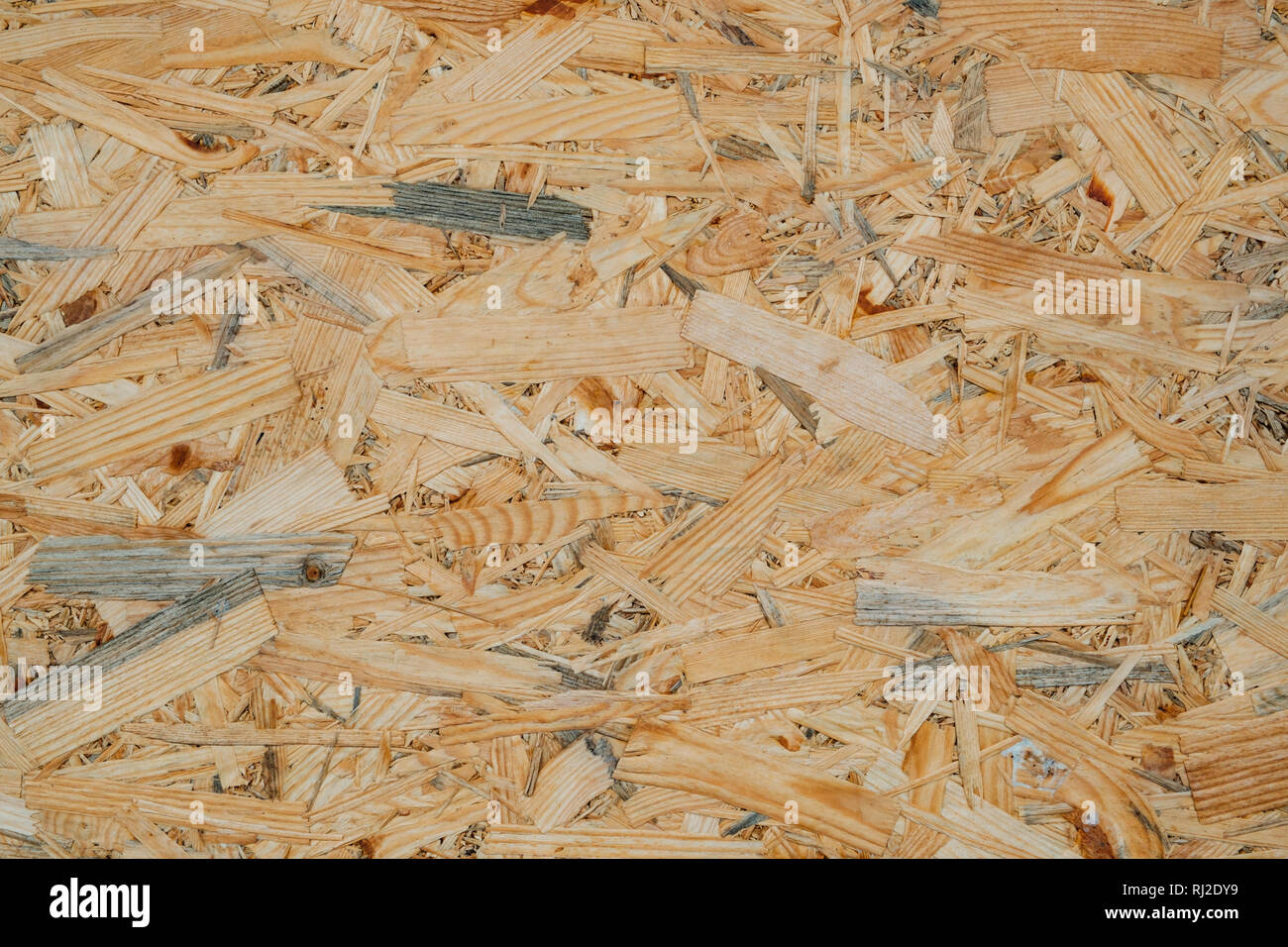 OSB pressed sawdust board made from wood chips, wooden texture and