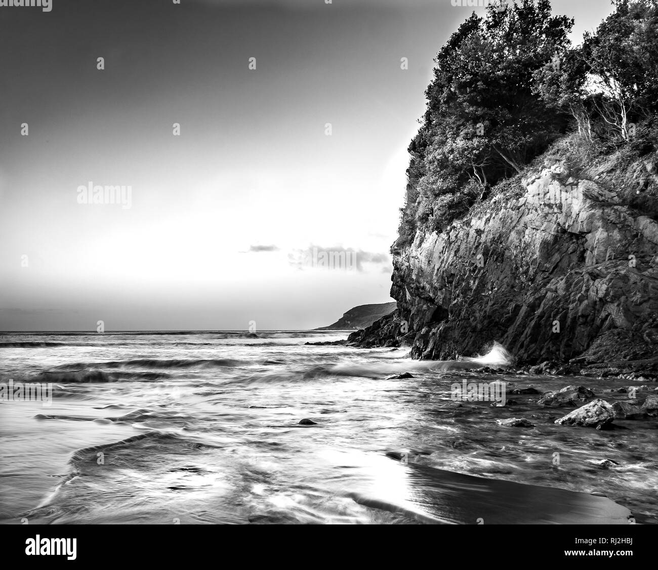 Black and white seascape image of Caswell Bay, The Gower Peninsular Stock Photo